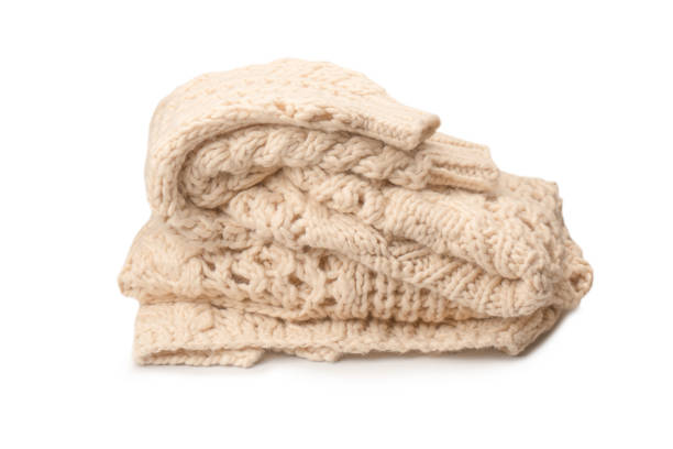 istock A fragment of beige knitted fabric, knitted from white sheep wool. 1483035596