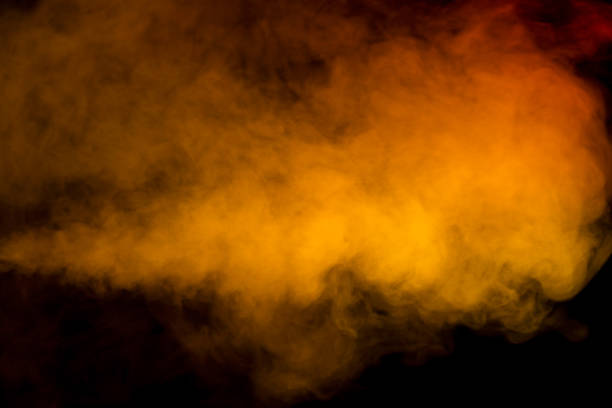 Orange and red steam on a black background. Copy space.