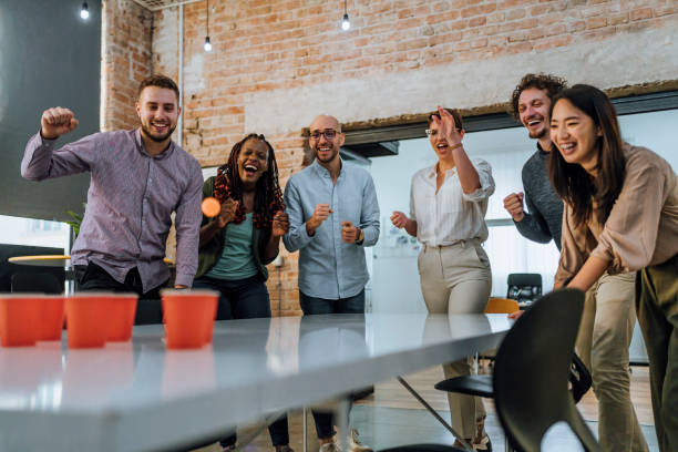 istock Coworkers playing beer pong in the office 1483035795