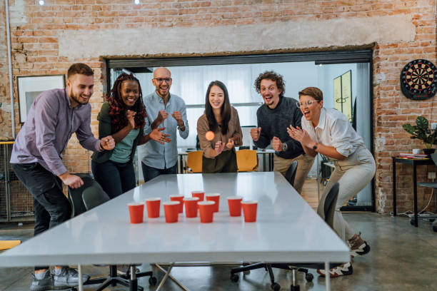 istock Young colleagues playing beer pong in the office 1483036777