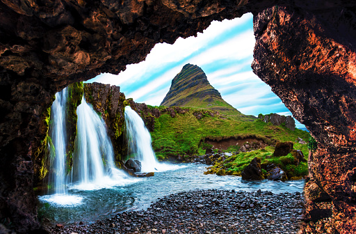 Non-standard view of waterfall Kirkjufell near the volcano in Iceland. Exotic countries. Amazing places. Popular tourist atraction.