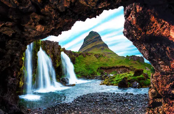 Photo of Non-standard view of waterfall Kirkjufell near the volcano in Iceland. Exotic countries. Amazing places. Popular tourist atraction.