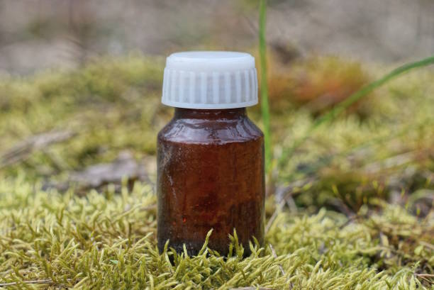istock one small glass brown medical bottle with a white cap 1483038700