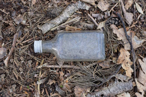 istock garbage from one old gray dirty empty glass vodka bottle 1483038790
