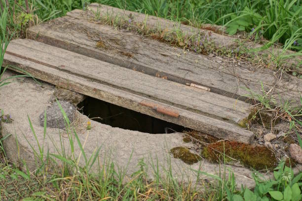 istock old sewerage with a gray concrete ring closed with wooden boards 1483038907