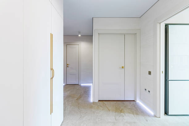 istock Modern entrance hall in light colors with interior doors in white and gold 1483038991