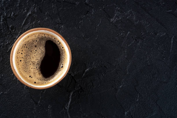 istock Coffee cup, shot from above on a black slate background with a place for text 1483039918