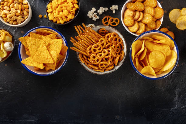 istock Salty snacks, party mix, overhead flat lay shot with copy space. An assortment 1483039932