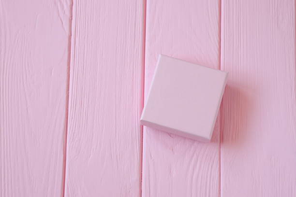 istock Pink present box on pink wooden background, mockup 1483040013