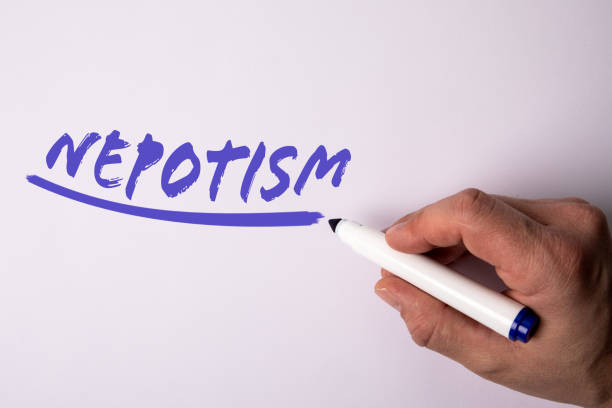 Nepotism. Handwriting text with marker on a white background