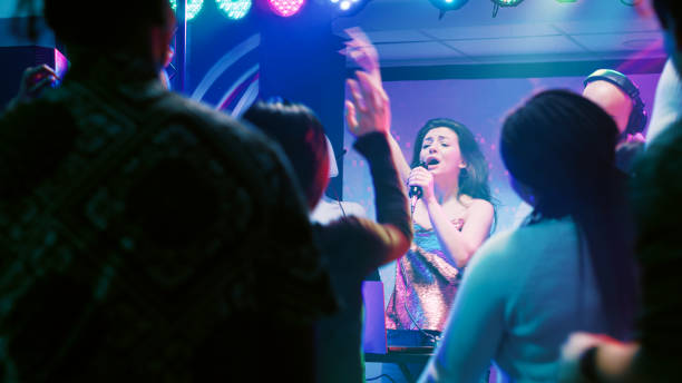 istock Confident woman doing karaoke on stage 1483042581