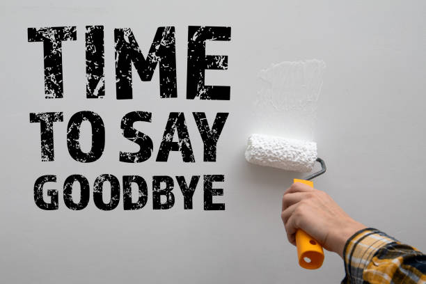istock Time To Say Goodbye. Painting a white wall with a paint roller in hand 1483042757