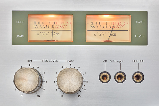 Retro styled image of a vintage silver audio cassette player with vu meters