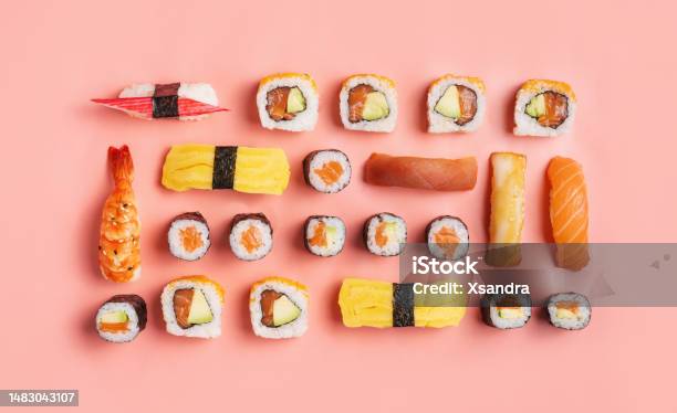 Food Knolling Concept Top Down View Of Various Nigiri Sushi And Sushi Rolls On Pink Background Stock Photo - Download Image Now