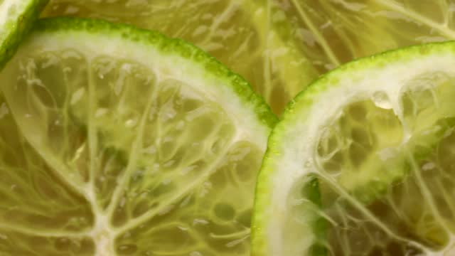 Close up of lime slices, rotation in circle. lime green Turning