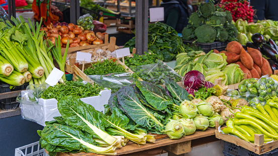 Street market in the Dutch capital Amsterdam. A market stall of fresh vegetables is on display for sale.