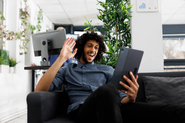 istock Cheerful arab entrepreneur greeting employees in digital tablet videocall 1483045305