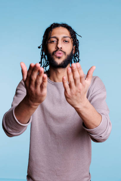 istock Charming arab man blowing romantic air kiss portrait 1483046167