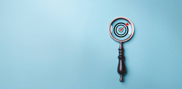 istock Target board inside vintage magnifying glass for focus business objective on blue background and copy space. Search, goal, strategy, success. successful marketing strategy goals 1483046747