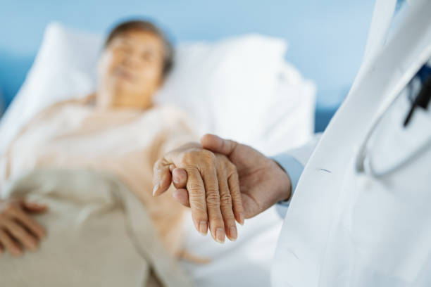 istock Doctor holding senior patient's hand after surgery 1483046822