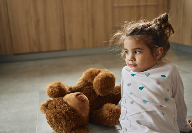 istock Small girl with chickenpox hugging teddy bear 1483047585