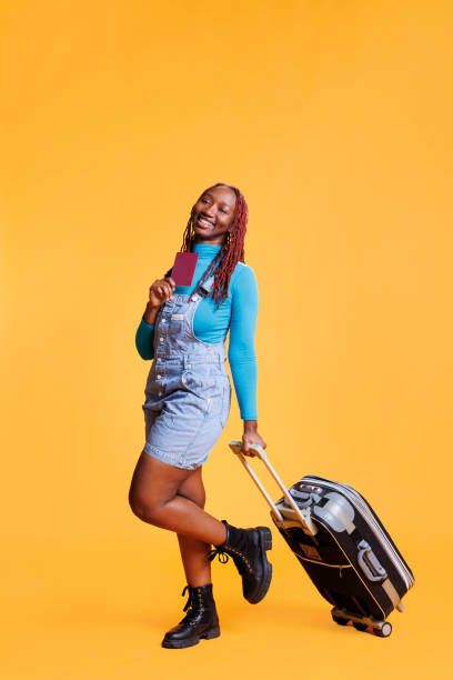 istock Woman with passport carrying trolley bag 1483048586