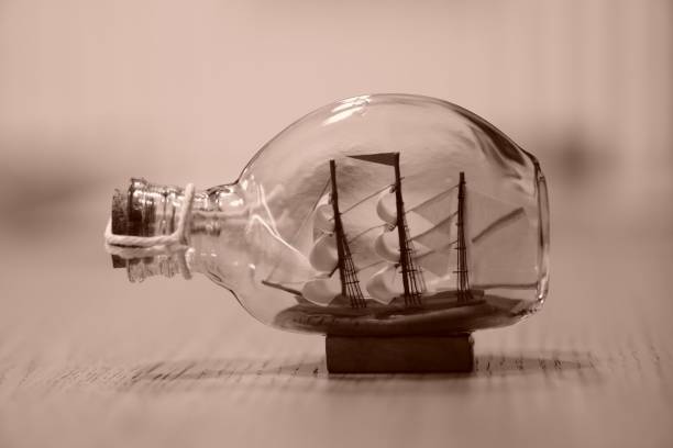 istock a ship in a bottle on a wooden table with a blurry background 1483050003