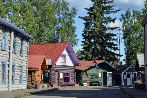 View of old, wooden Gold Rush Era houses put together in a public skansen Pioneer Park in Fairbanks, Alaska, USA.