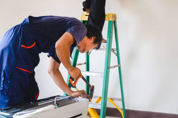 istock Technician man installing air conditioning in a client house, Young repairman fixing air conditioner unit, Maintenance and repairing concepts 1483051587