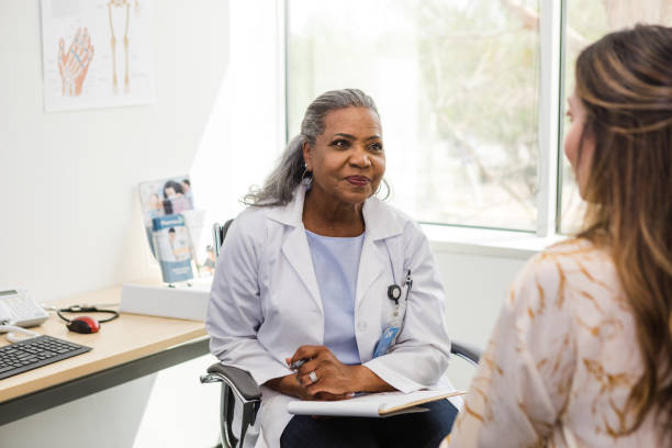 istock Female doctor looks at her patient as they talk about her concerns 1483052006