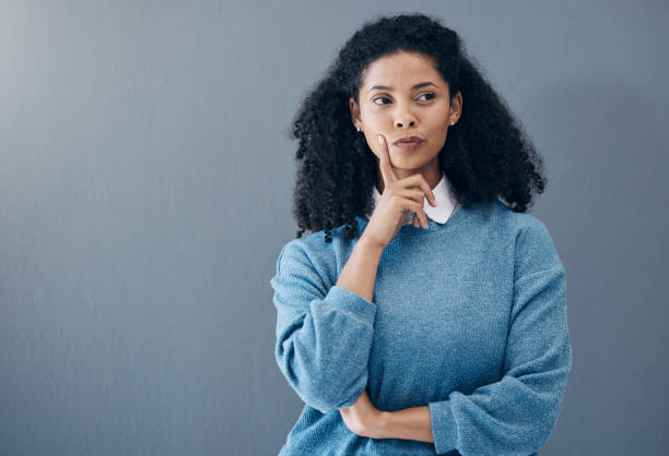 istock Thinking, thoughtful and woman in a studio with an idea, smart question or plan in her head. Contemplating, pensive and doubtful female model from Mexico isolated by gray background with mockup space 1483052164