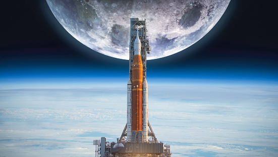 Spaceship on launch pad. Mission to Moon. Return on Moon. SLS space rocket. Orion spacecraft. Artemis space program to research solar system. Elements of this image furnished by NASA (url:https://images-assets.nasa.gov/image/PIA00405/PIA00405~small.jpg https://www.nasa.gov/sites/default/files/thumbnails/image/ksc-20220318-ph-kls03_0079large.jpg)