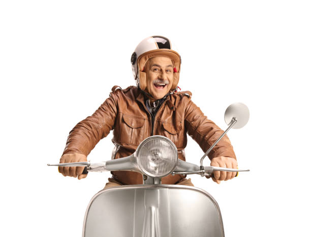 Cheerful mature man riding a silver scooter and smiling isolated on white background