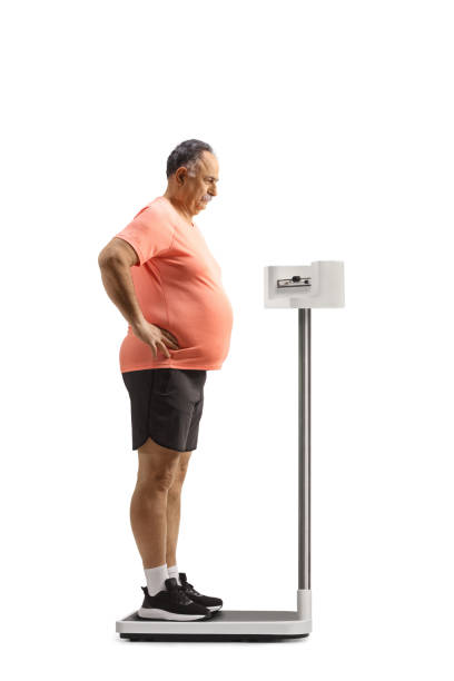 istock Worried mature man standing on a medical weight scale 1483057192
