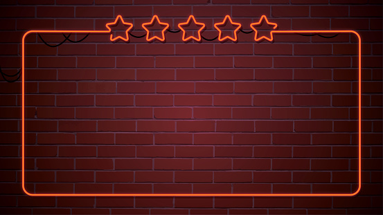 Neon illuminated red five stars sign on a brick wall