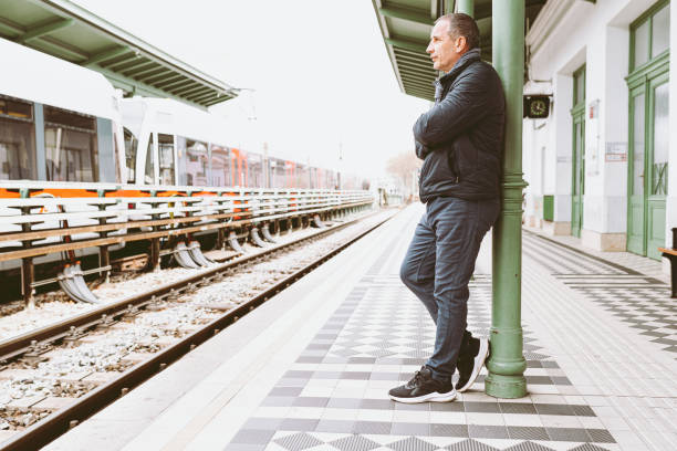 istock Mature man waiting for train at platform of railway station 1483063306