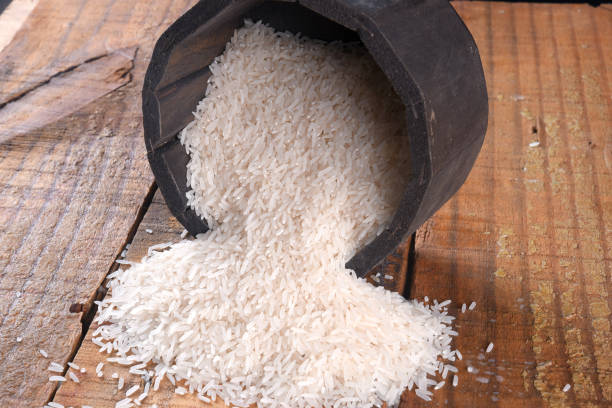 istock white rice natural long rice grain in wooden bowl use texture background 1483063474