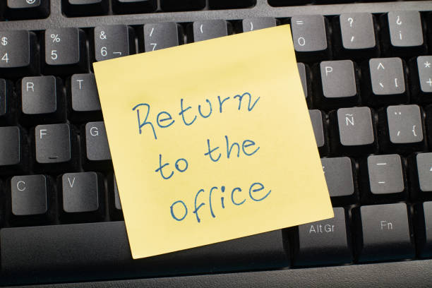 istock A black computer keyboard and a paper note with return to the office phrase in a close up view 1483064459