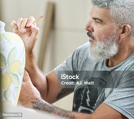 istock Mature worker painting a vase in a ceramics factory 1483065478