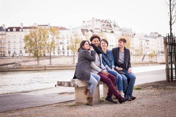 Diverse group of friends enjoying being together, talking and laughing in Paris, France, Latin Quarter on a sunny spring day.