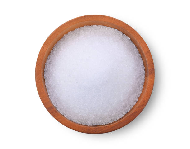 sugar in wooden bowl on white background. Top view