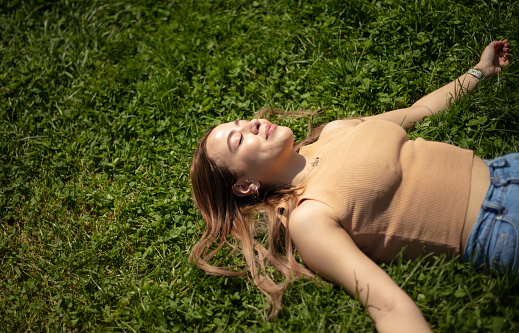 Lying on the grass is an activity that many people do that is good for human health.