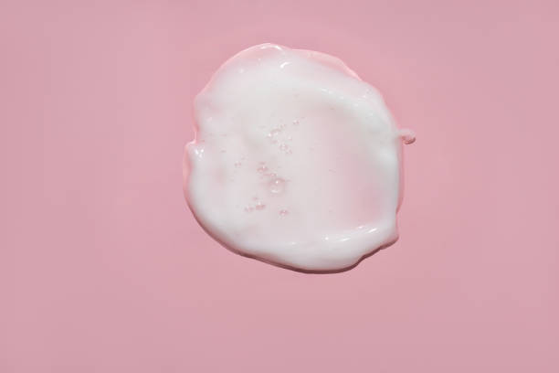 istock white cream with bubbles swatch on pink background 1483067567