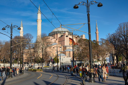 Istanbul, Turkey - Jan 9, 2023: Istanbul city street view with Hagia Sophia mosque, ordinary people walk nearby