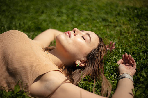 Lying on the grass is an activity that many people do that is good for human health.