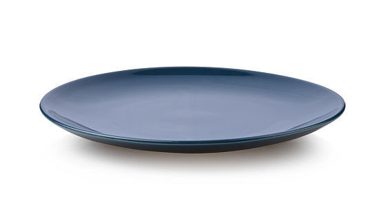 Deark blue ceramic plate ioslated on white bacckground.