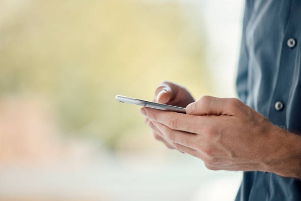 istock Man hands, phone and mobile networking of a businessman in a office on web. Online communication, text writing and technology of a social media writer employee with mock up and blurred background 1483067894