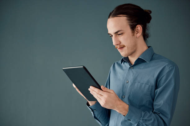 istock Digital tablet, mockup and man in studio on internet, search or communication advertising on black background. App, website and businessman online schedule, planning and project, isolated and space 1483067929