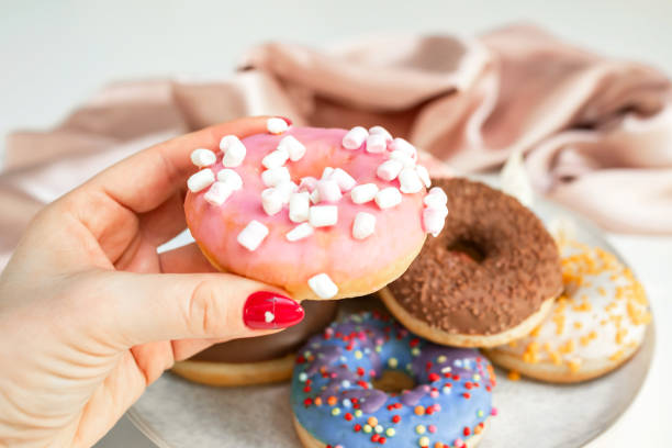 istock Hand takes a donut from a plate 1483070113
