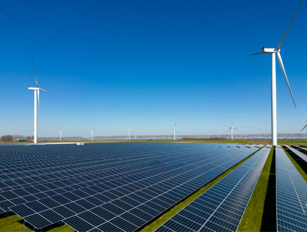Solar panel and wind turbine farm clean energy. stock photo